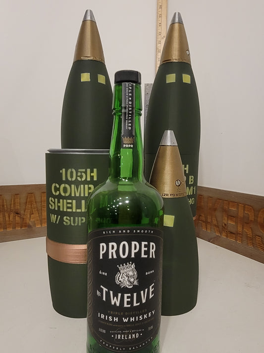 105mm M1 Whiskey Stash replica opened beside a 750ml whiskey bottle